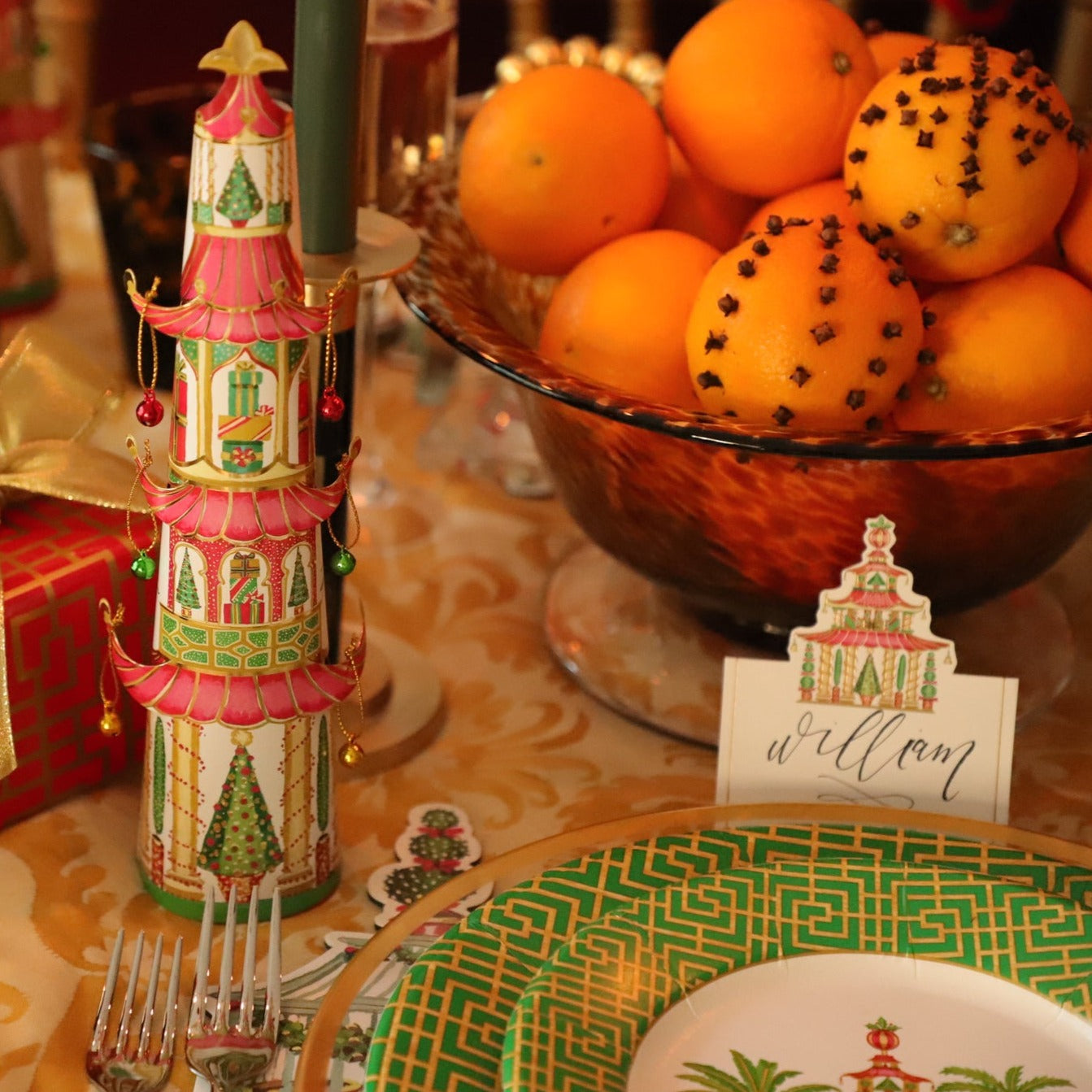 Christmas table scene showing pagoda design paper plates, place card and other Christmas table decorations