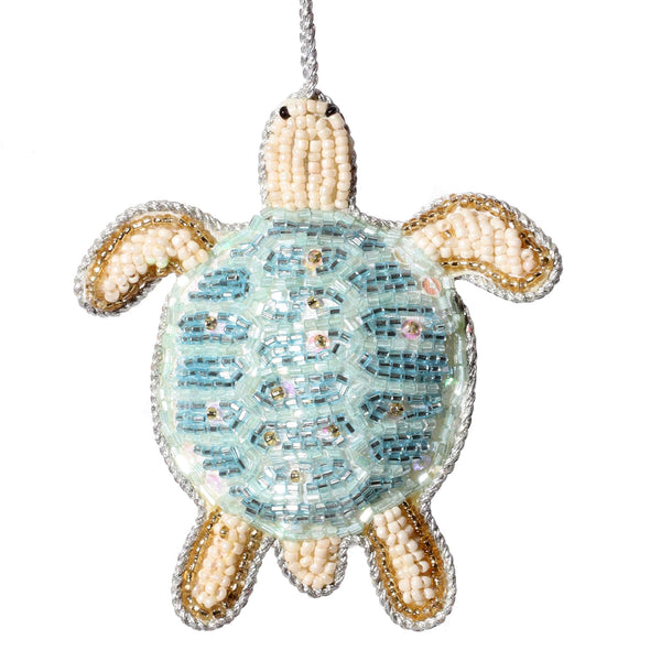 beaded hanging turtle christmas decoration in soft blues and naturals and gold.
