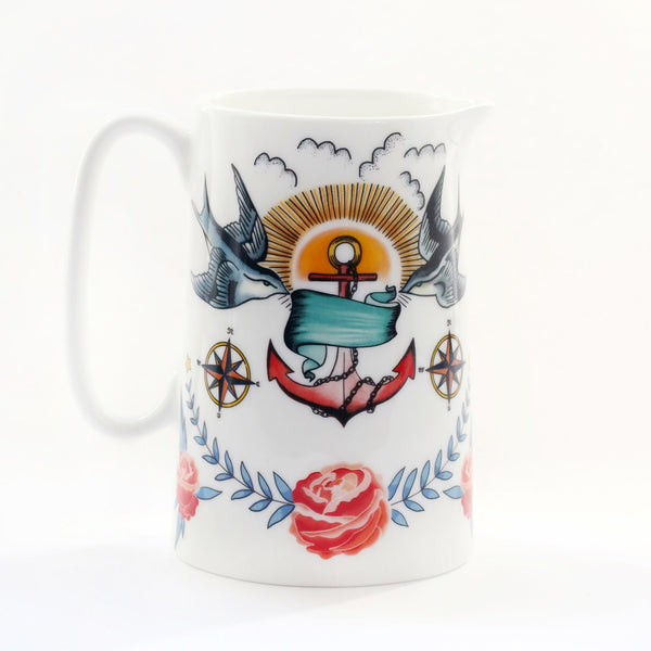 White bone china jug with brightly coloured tattoo inspired design of swallows, anchor and roses.