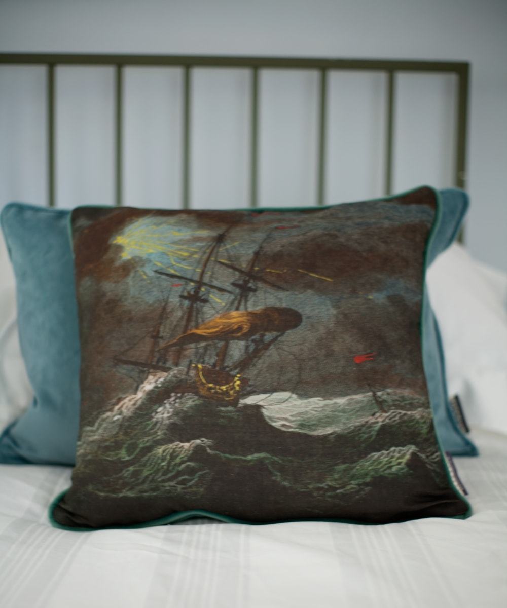 Shipwreck night square cushion placed on a bed