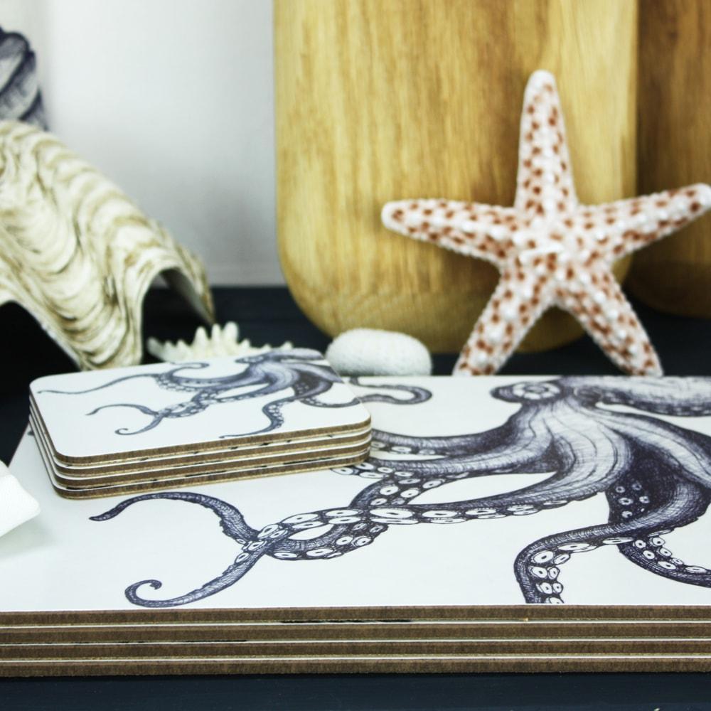 Octopus  Design in Navy on a white Coaster with a matching Placemat.On the table are decorative shells and a matching napkin