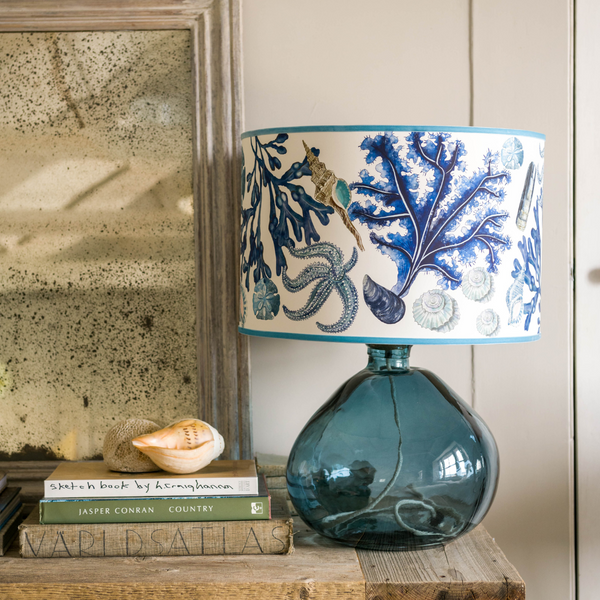 Lifestyle shot of beautiful lampshade with clear petrol blue base. 