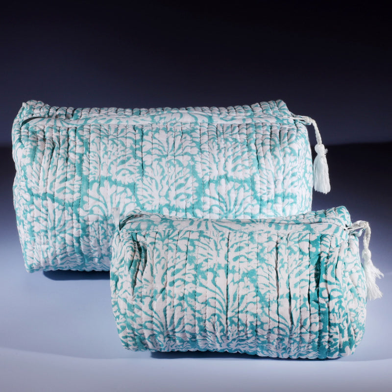 Tubular shaped cosmetic bag with Summer Skies Coraline design,the larger one placed behind the smaller one.
