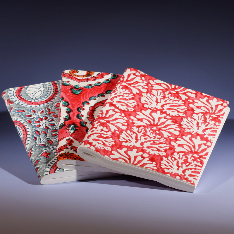 Three medium hand block printed notebooks displayed together