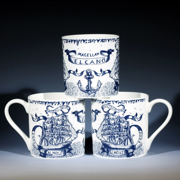 The photo shows Bone China White Mug Tall Ships commemorative design,hand drawn illustration with a Tall ship central surrounded by flags,banners and an anchor all in Navy 
