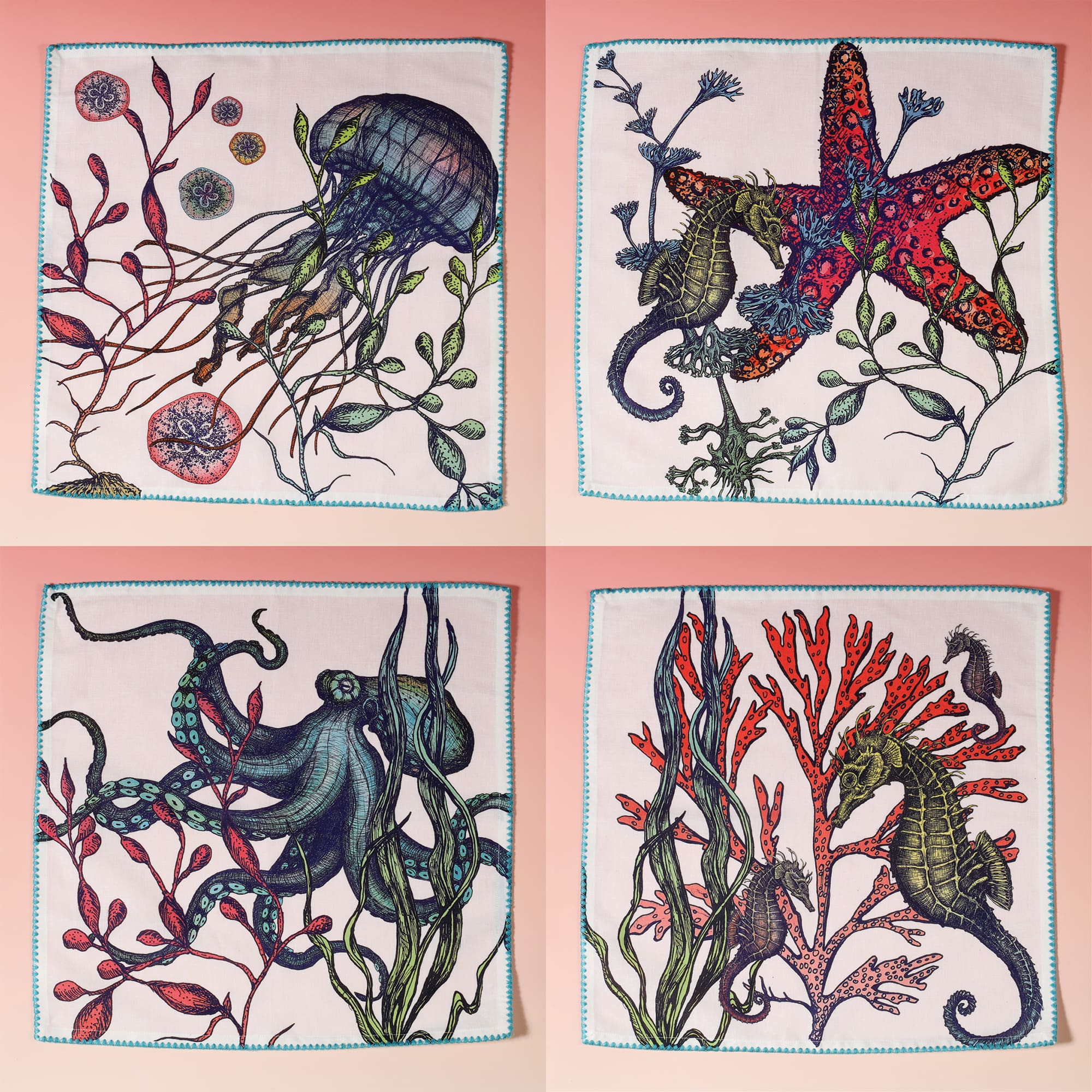 Set of 4 brightly coloured off white linen napkins with hand drawn seahorse, starfish, octopus and jellyfish illustrations and turquoise scallop edged embroidery opened out to display all four