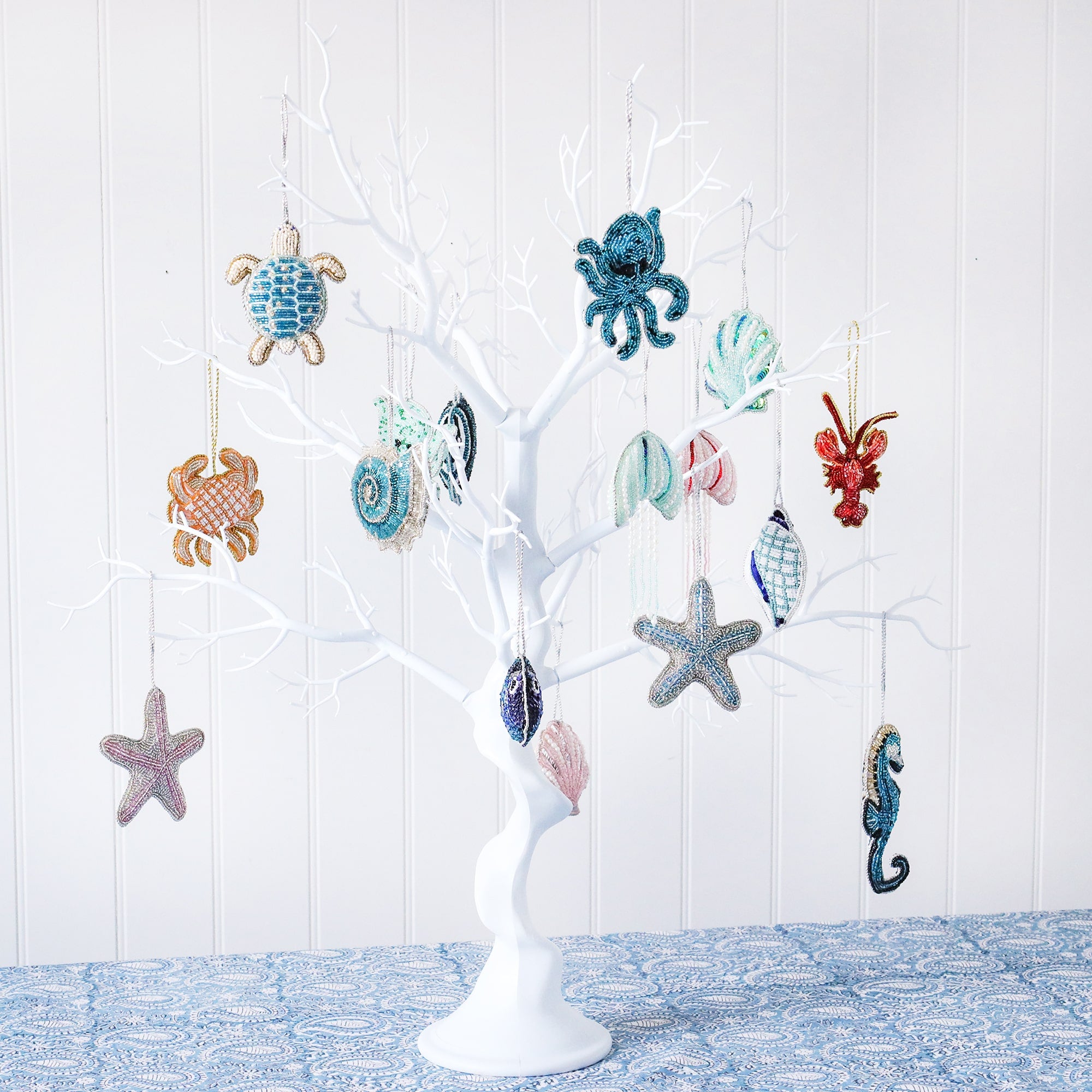 White tree display  with our selection of beaded decorations including octopus,crab,turtle,starfish,seahorse, lobster angel fish,scallop shell,fish conch shell and ammonite