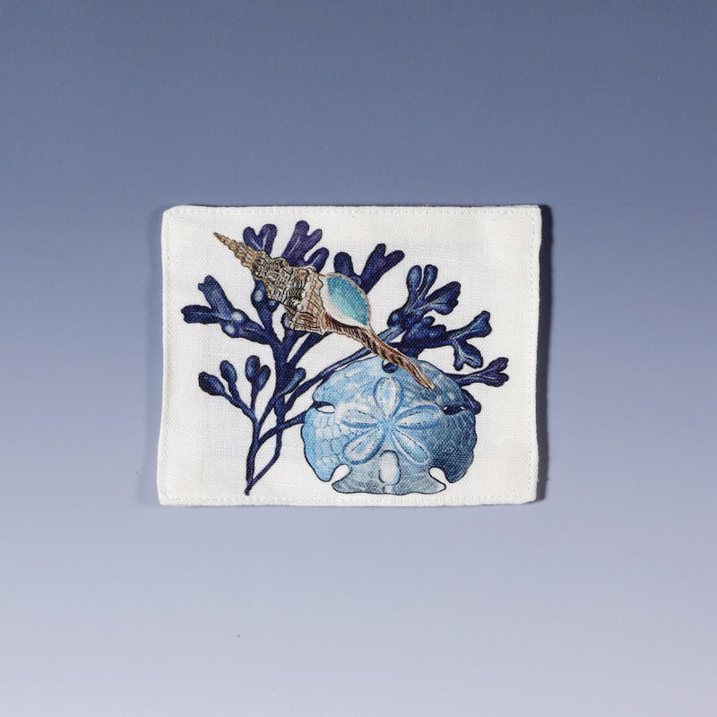 Cotton and linen mix white fabric rectangular coaster.Design on both sides is  hand drawn seaweed,a sand dollar in shades of blue .Set of four