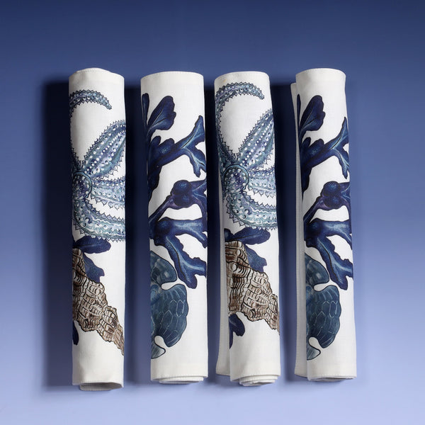 Cotton and linen mix white fabric rectangular placemats identical design on both sides.Rolled up next to each other showing different sides,Set of four