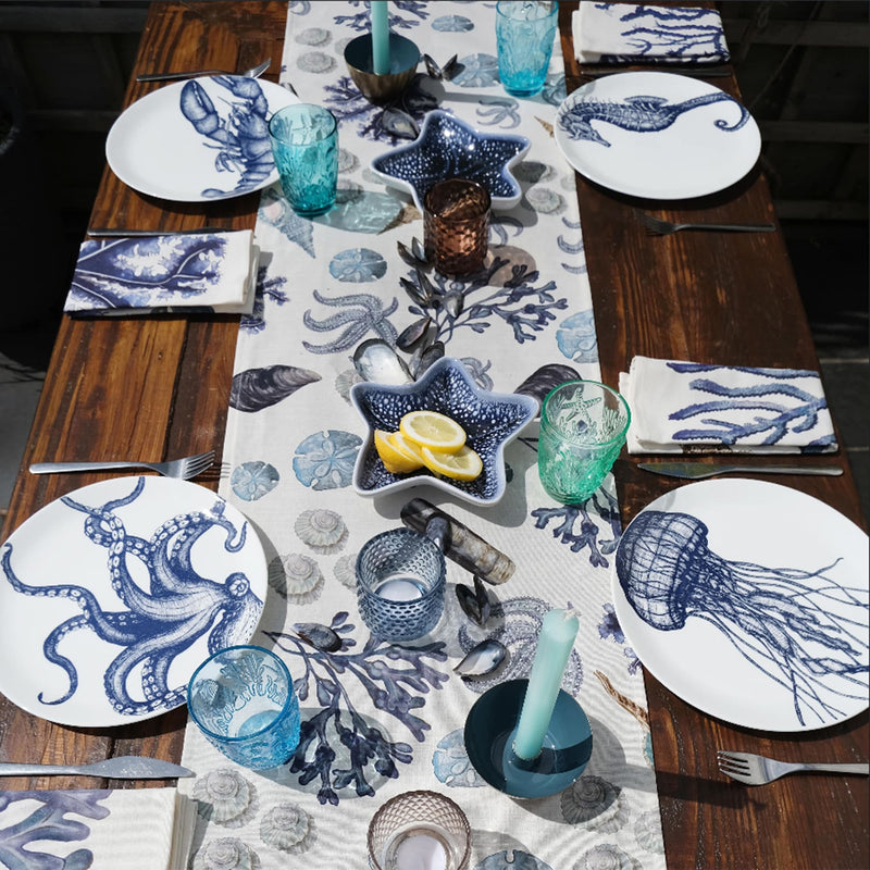 Cotton and Linen mix table runner with hand drawn illustrations with our Rockpool design on a table decorated with our classic plates,cutlery,glassware and other table decorations
