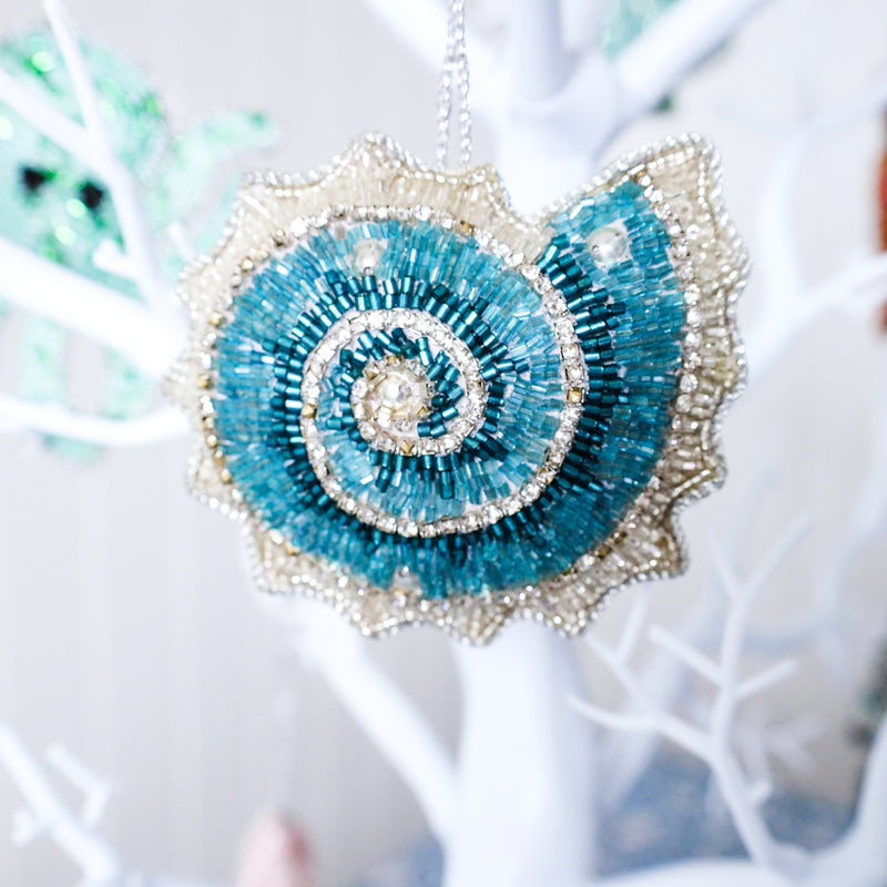 beaded blue and silver christmas decoration in the shape of an ammonite reverse view