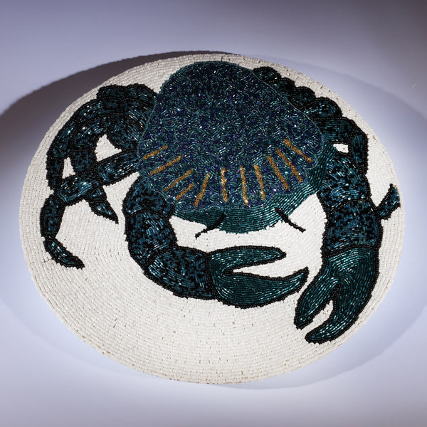 Handmade glass beaded placemat with a Crab design in Navy,Black and gold on white glass beads