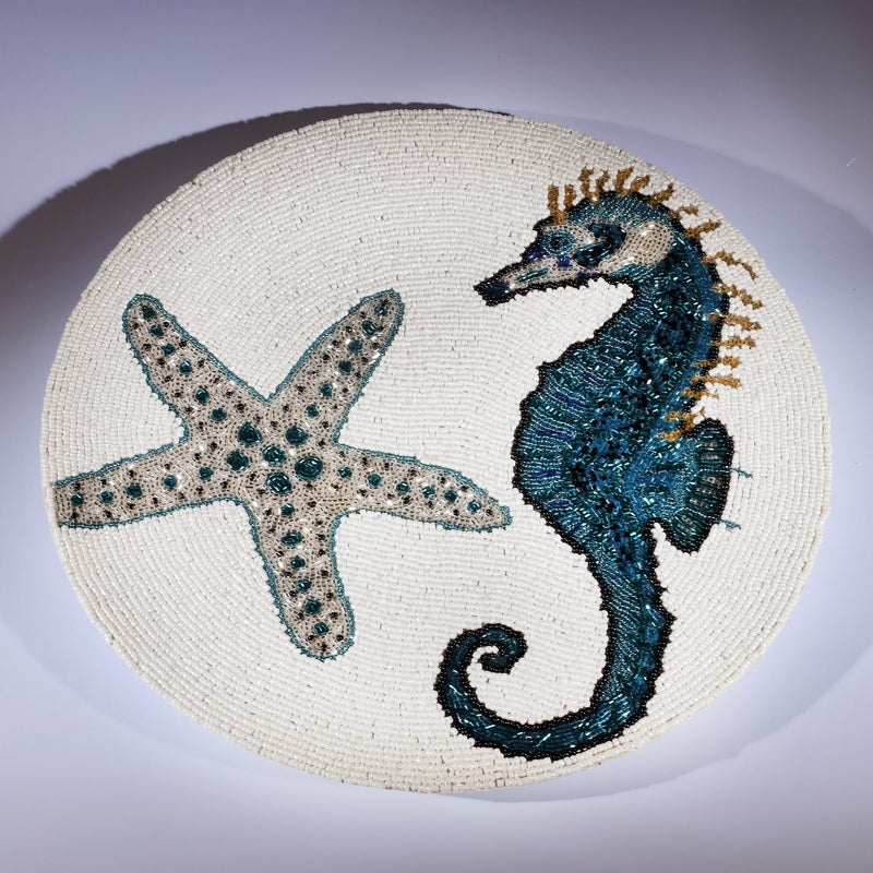 Handmade glass beaded placemat with a Seahorse and Starfish design in Navy,Black and gold on white glass beads