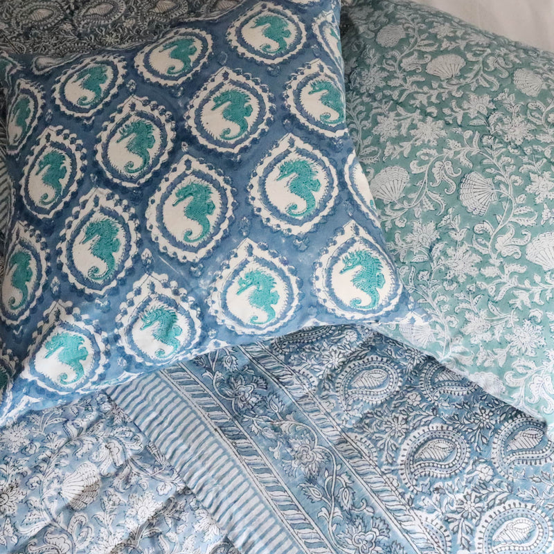 Hand block printed cushions on a pile on our Paisley Shell quilt cover
