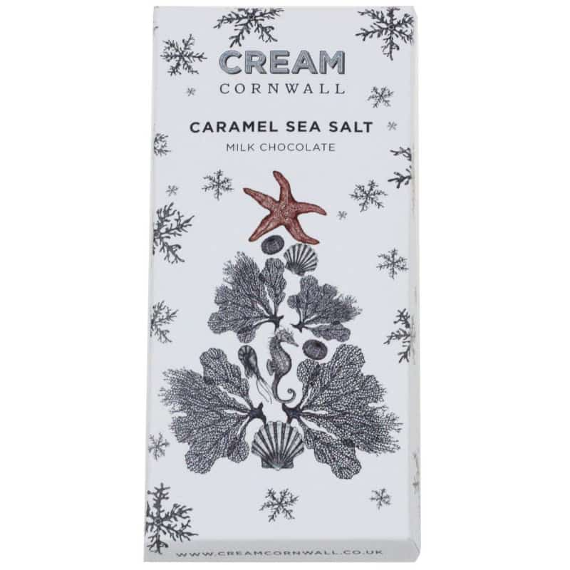 Cream Cornwall Nadelik Lowen Caramel Sea Salt Milk Chocolate bar with festive coastal-themed packaging. “Nadelik Lowen,” meaning Happy Christmas in Cornish, adds a special holiday touch. Ideal as a holiday treat or Christmas gift.