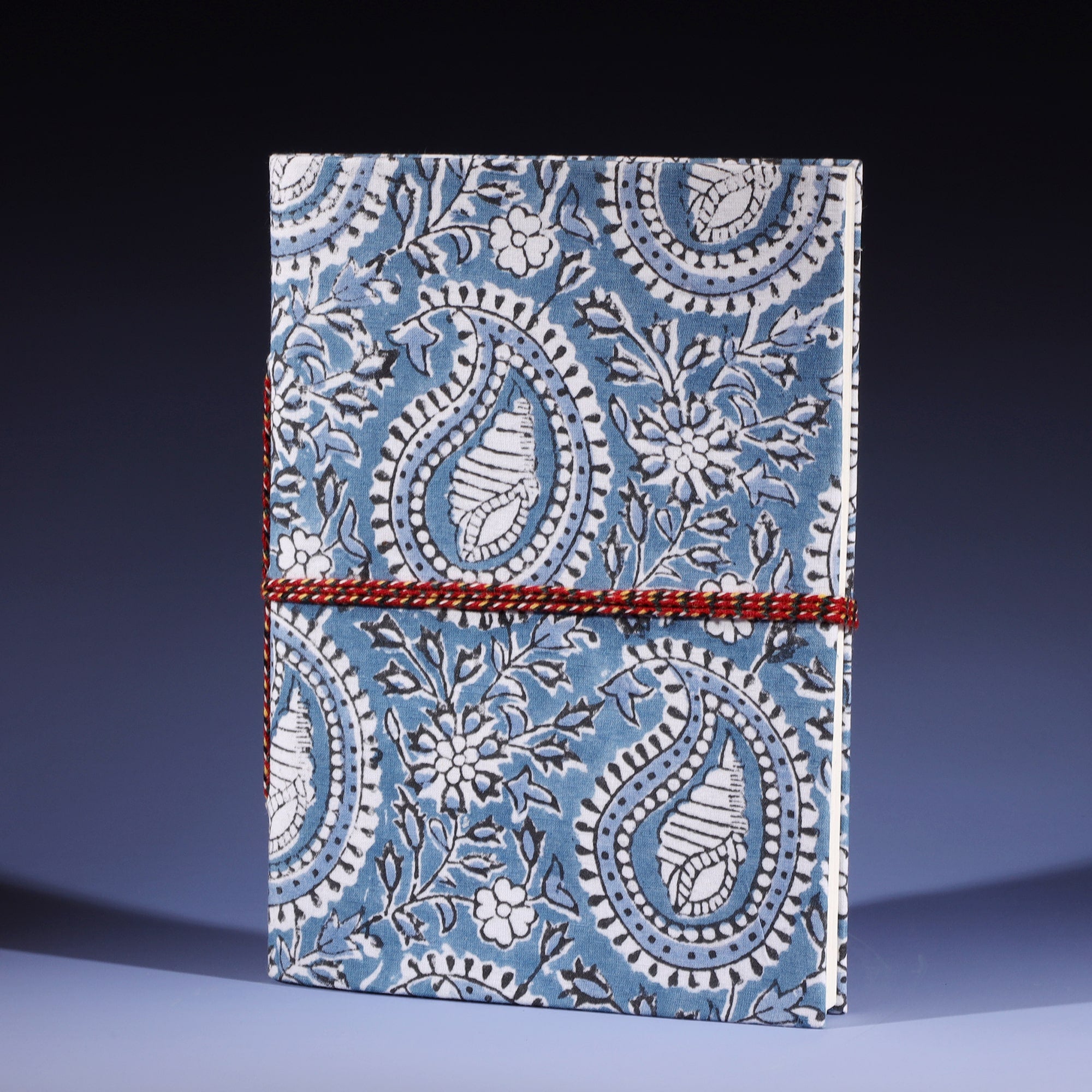 Hand Block printed hard backed notebook Paisley Shell in Azure on its side with fabric twine
