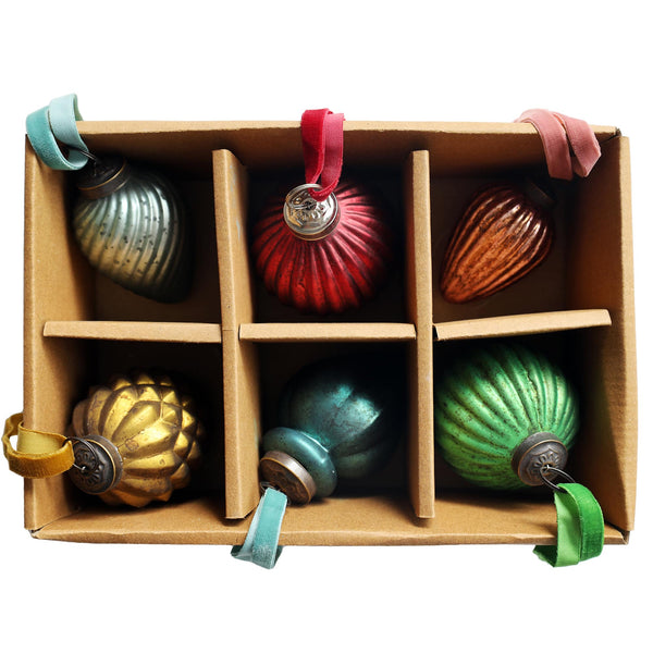 a six compartment box with different coloured vintage inspired glass baubles in each compartment