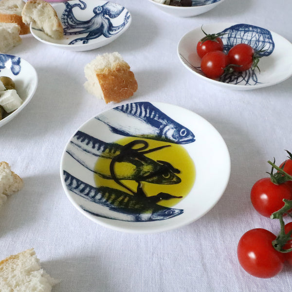 Nibbles bowl in Bone China in our Classic range in Navy and white in the Mackerel design with balsamic vinegar in placed on a white table cloth 