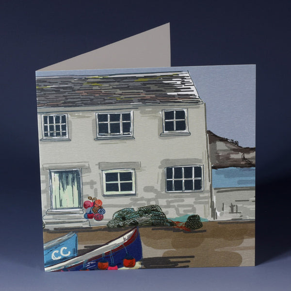 greeting card with illustration of a classic fishermans cottage with bouys, lobster pots and boats 