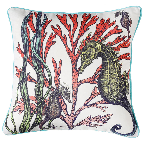 White piped linen cushion with Turquoise back.Front has hand drawn illustrations of Seahorses swimming amongst red and green Seaweed