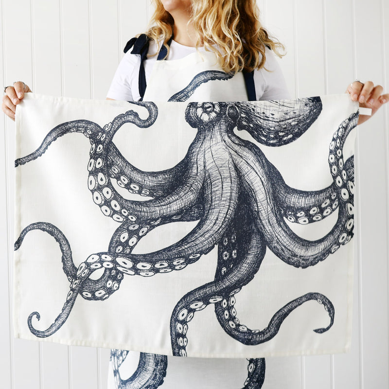 Model wearing our Octopus Apron holding a matching tea towel