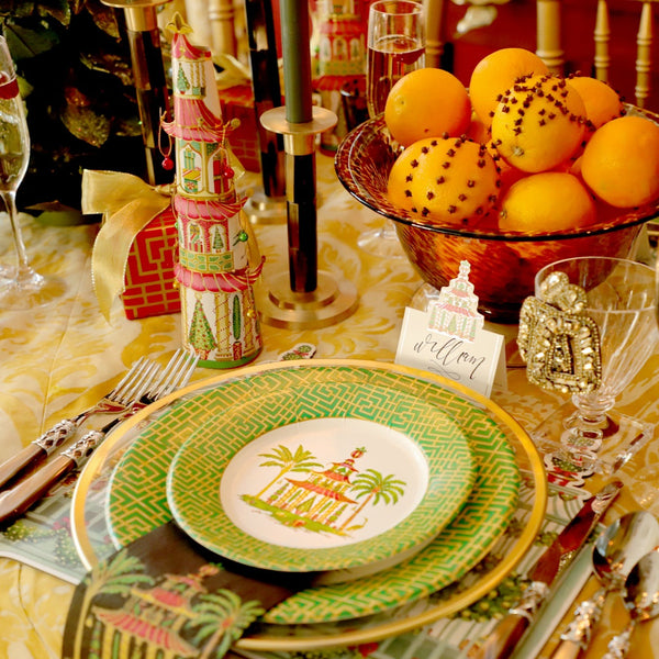 Christmas table scene showing pagoda design paper plates, place card and other Christmas table decorations