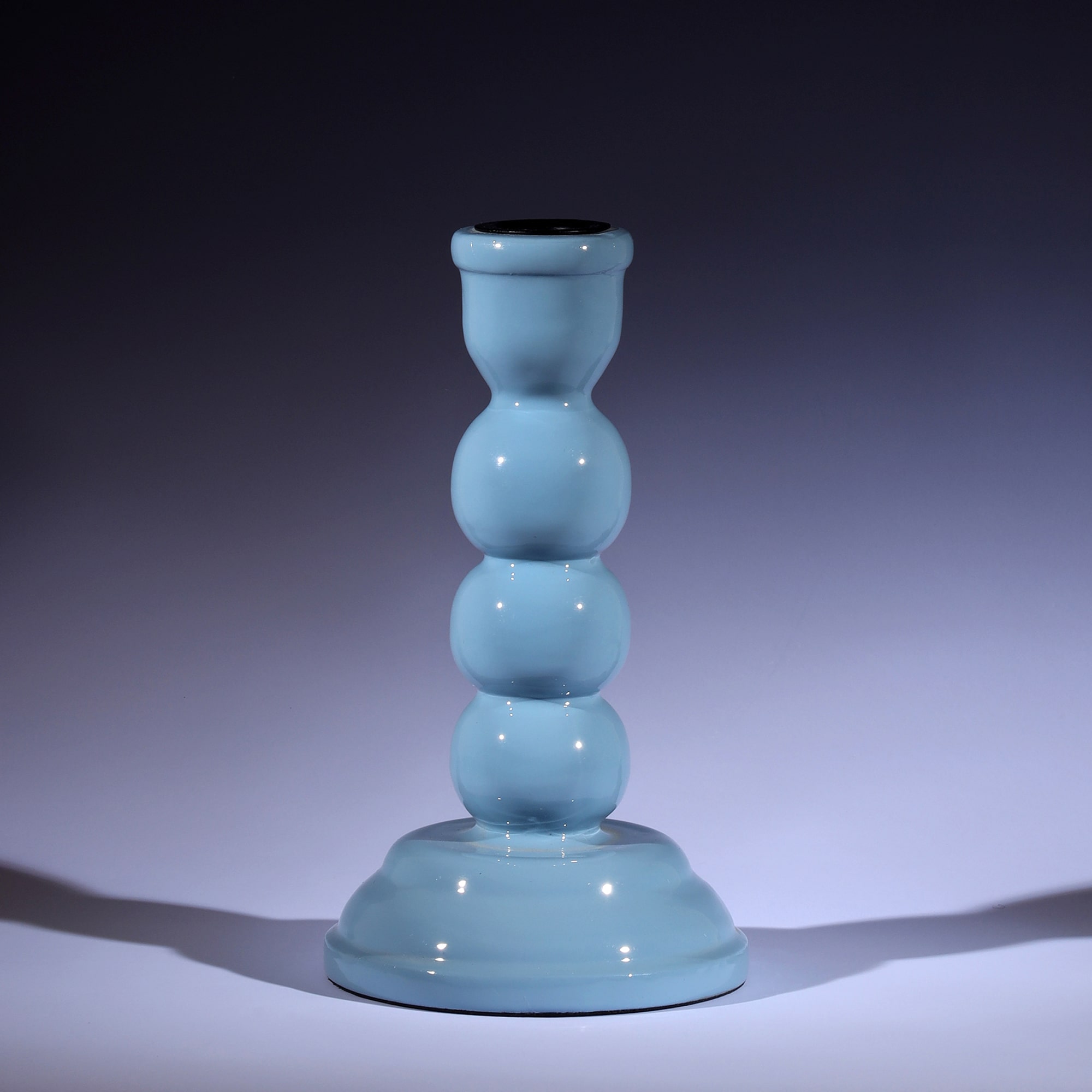 Powder Blue Polished Lacquer Candle holder,it is shaped like three solid circles on top of a tapered base