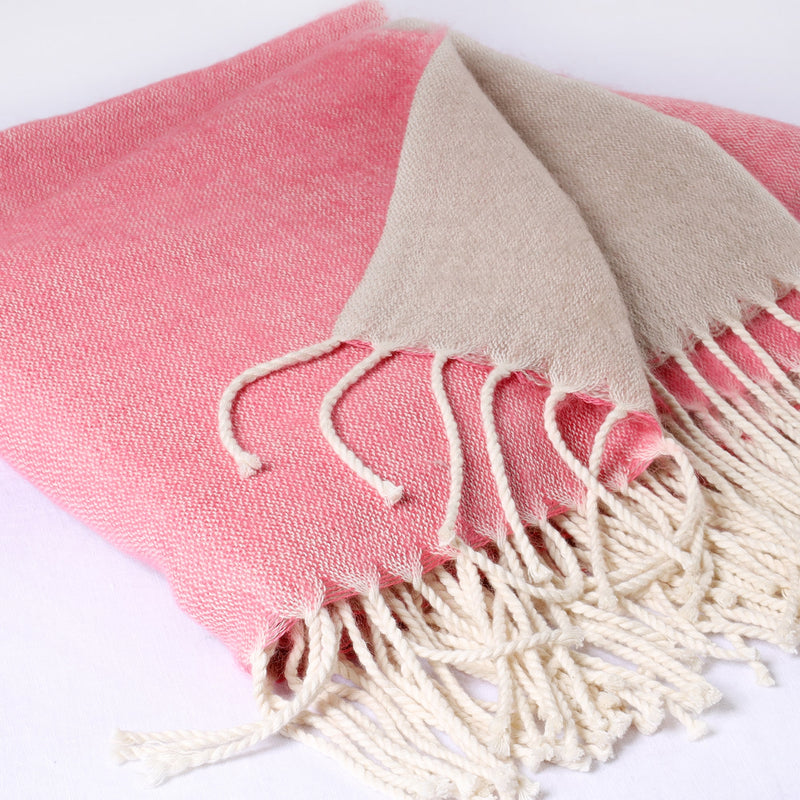 folded pink & natural reversible brushed throw on white background showing the weave and twisted fringe detail 