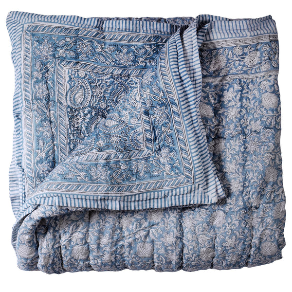 Paisley Shell Hand Blocked Quilt cushion which is Hand block printed fabric in a soft blue and white, the print is a repeat paisley with a shell theme throughout with swirling flowers.Edged in a soft blue and white stripe.