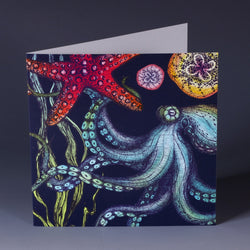 brightly coloured greeting card with octopus, starfish seaweed and baby jellyfish on a dark navy background