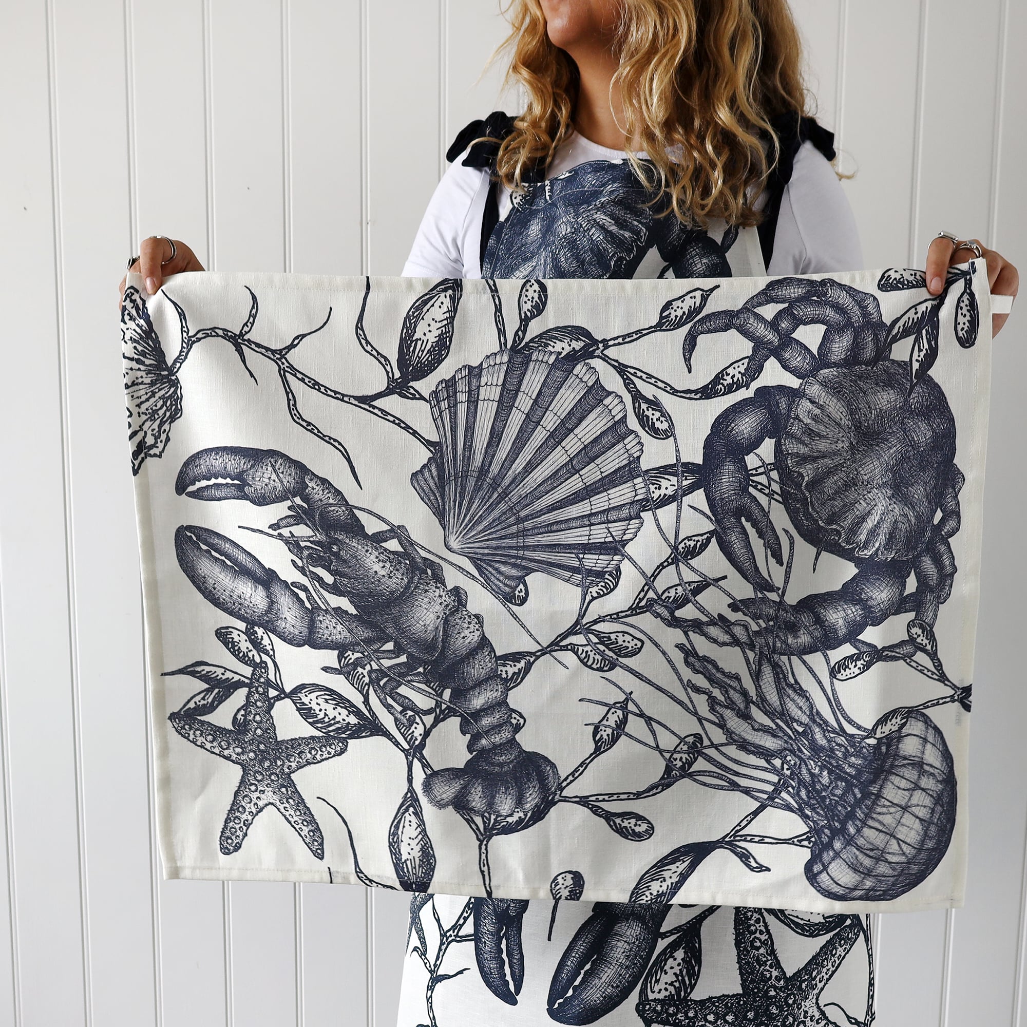 Model wearing our Sea creature Apron holding a matching tea towel