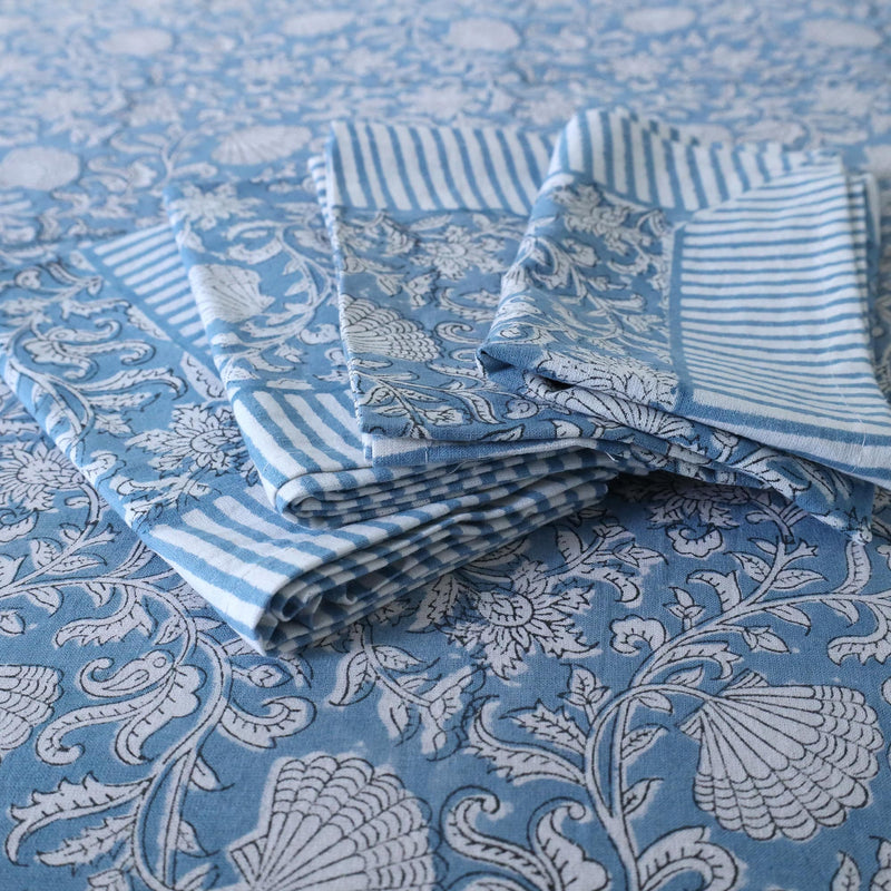 Seashell Flower tablecloth which is a Hand block printed fabric .Placed on the tablecloth are four matching napkins.