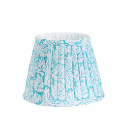 Small pleated Summer Skies Coraline pleated lampshade in hand blocked print in blue and white.Finished on the edge with fabric and lined in white.