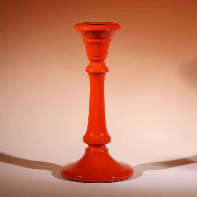 Sunset Polished Lacquer Candle holder,tapered at the top,moving down it has various section and a long smooth piece to finish with a tapered base