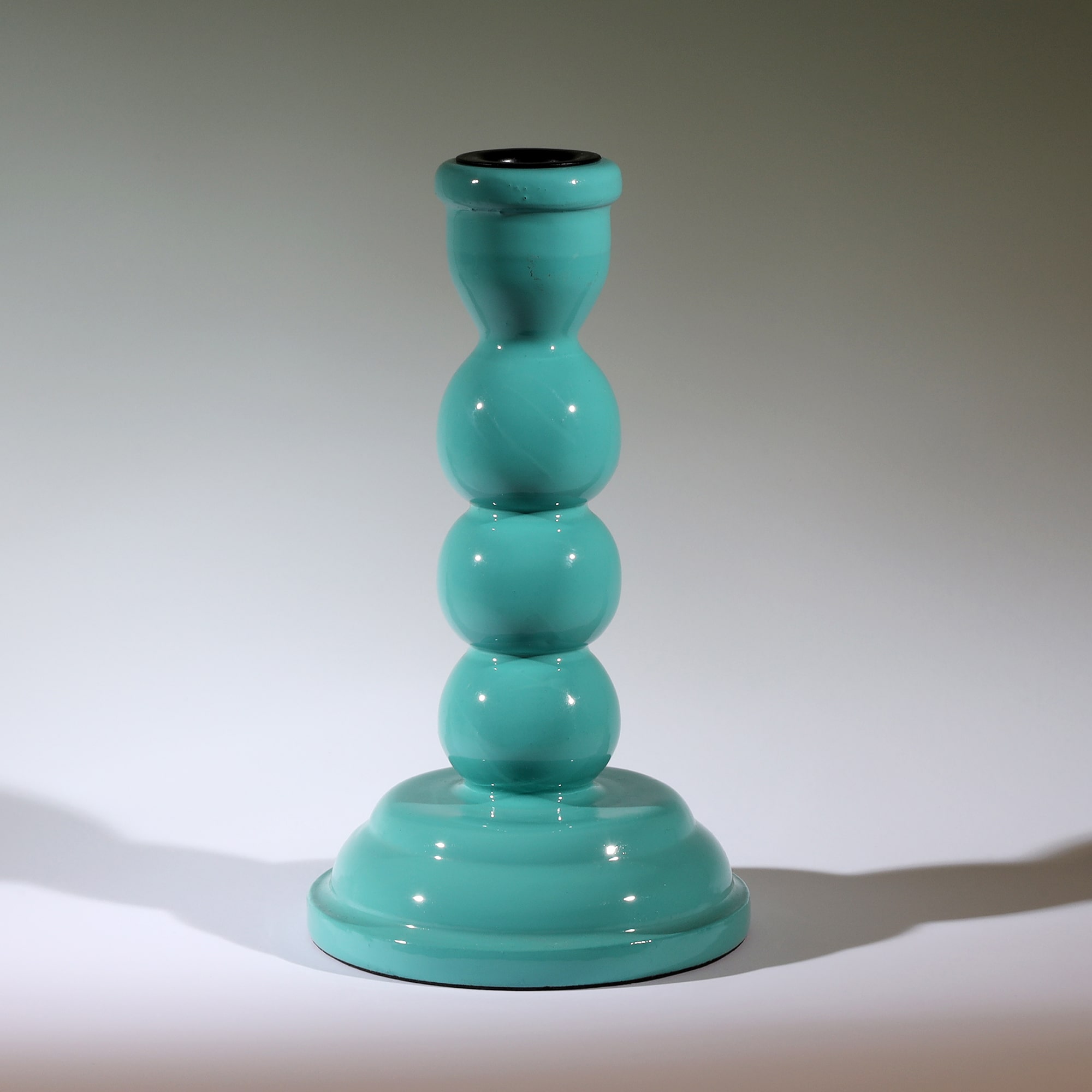 Turquoise Polished Lacquer Candle holder,it is shaped like three solid circles on top of a tapered base