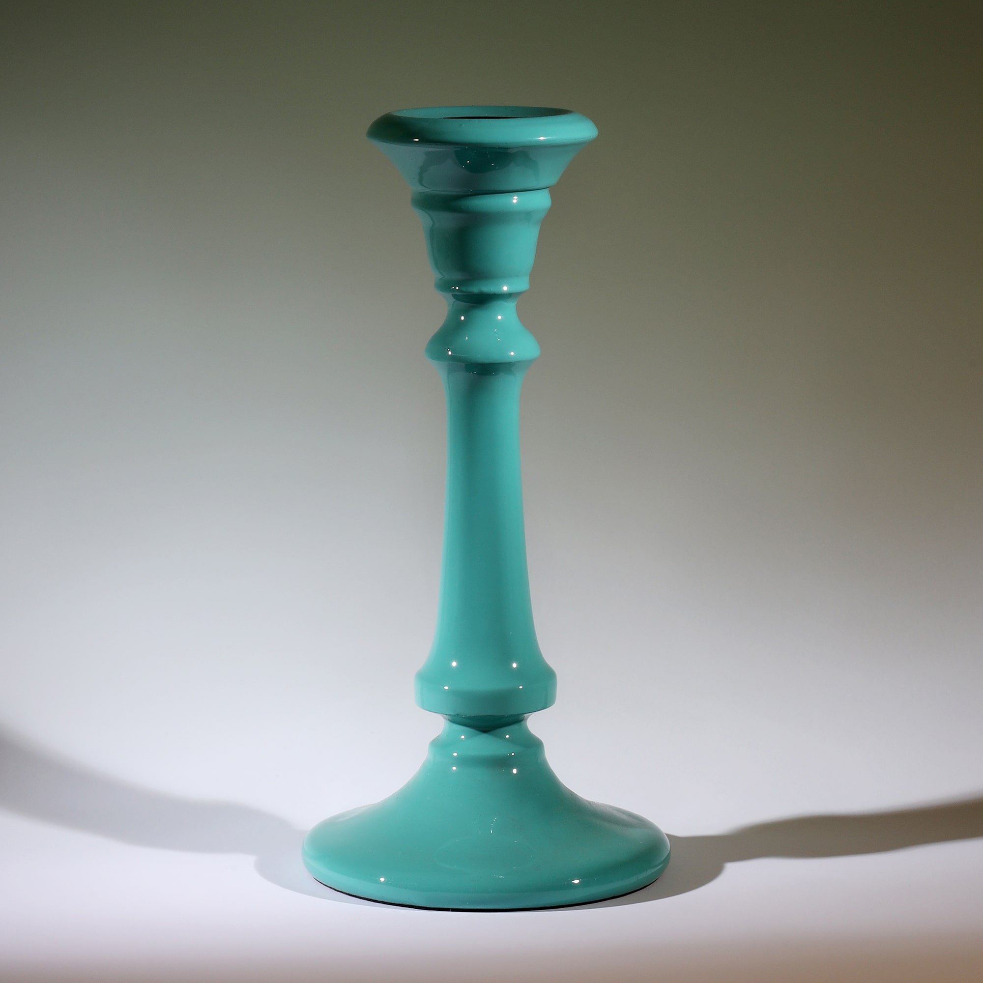 Turquoise Polished Lacquer Candle holder,tapered at the top,moving down it has various section and a long smooth piece to finish with a tapered base