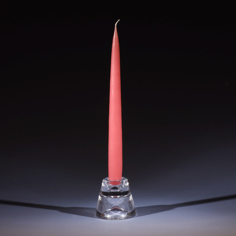 vintage rose tapered dinner candle in a small glass candle holder on an ombre blue background