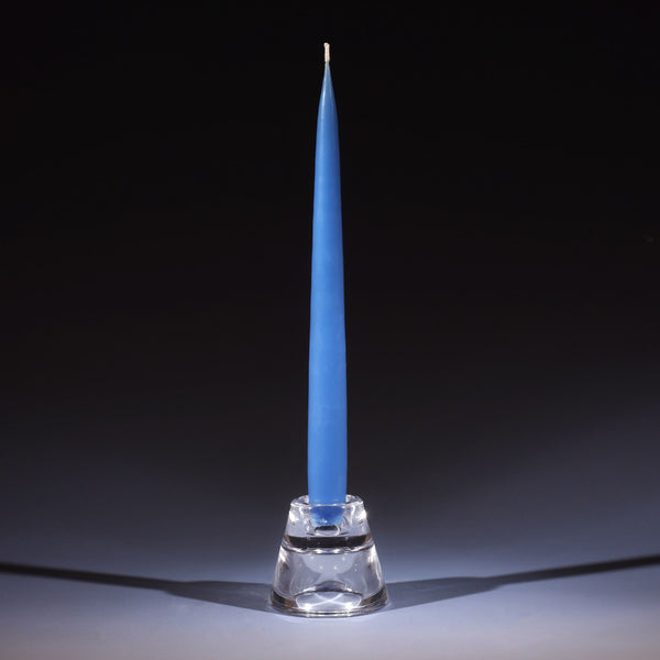 wedgewood blue tapered dinner candle in a small glass candle holder on an ombre blue background