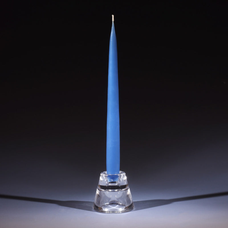 wedgewood blue tapered dinner candle in a small glass candle holder on an ombre blue background