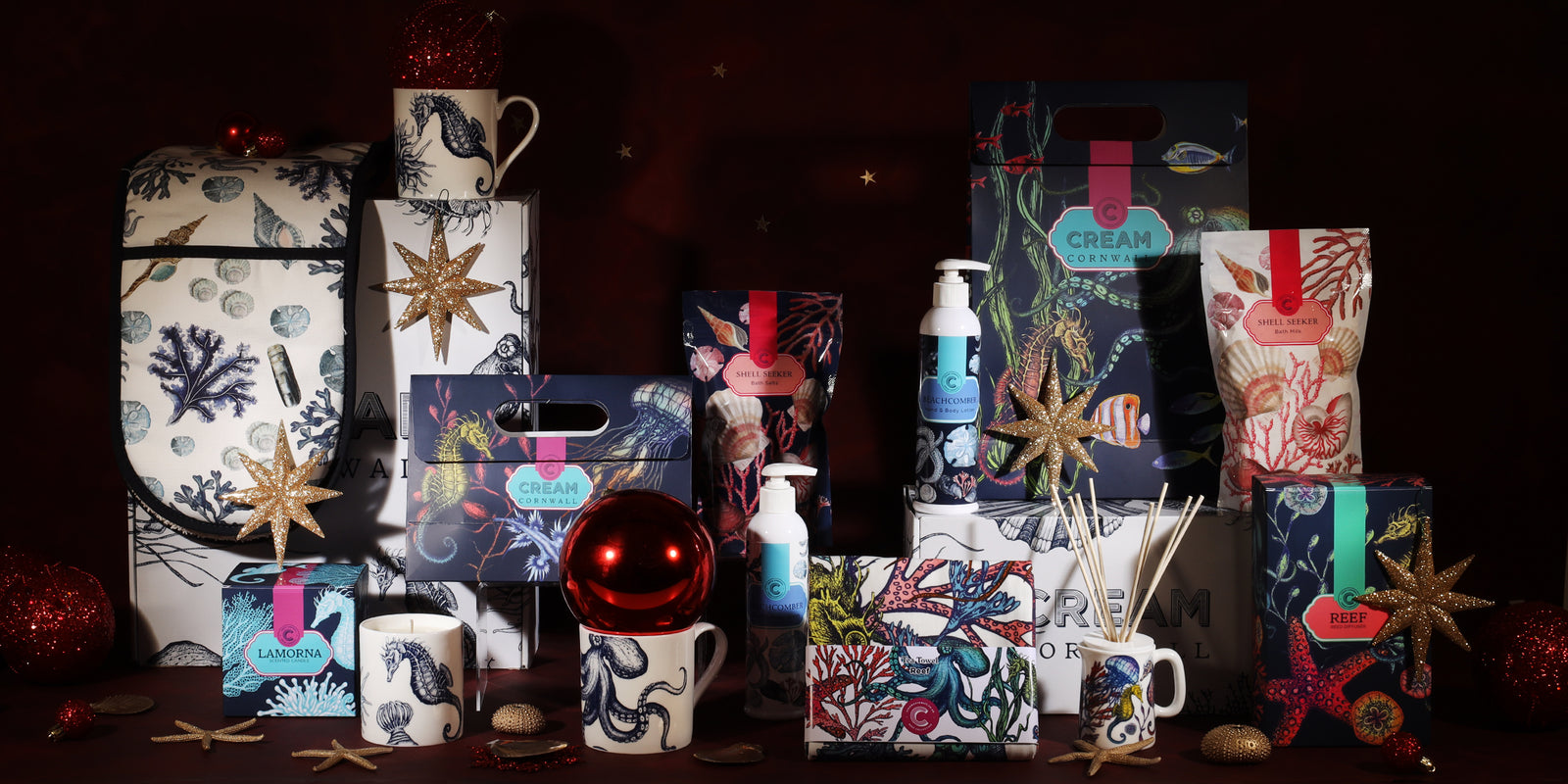 Luxury display of Cream Cornwall products such as bone china mugs, linen tea towels, thick & padded oven gloves