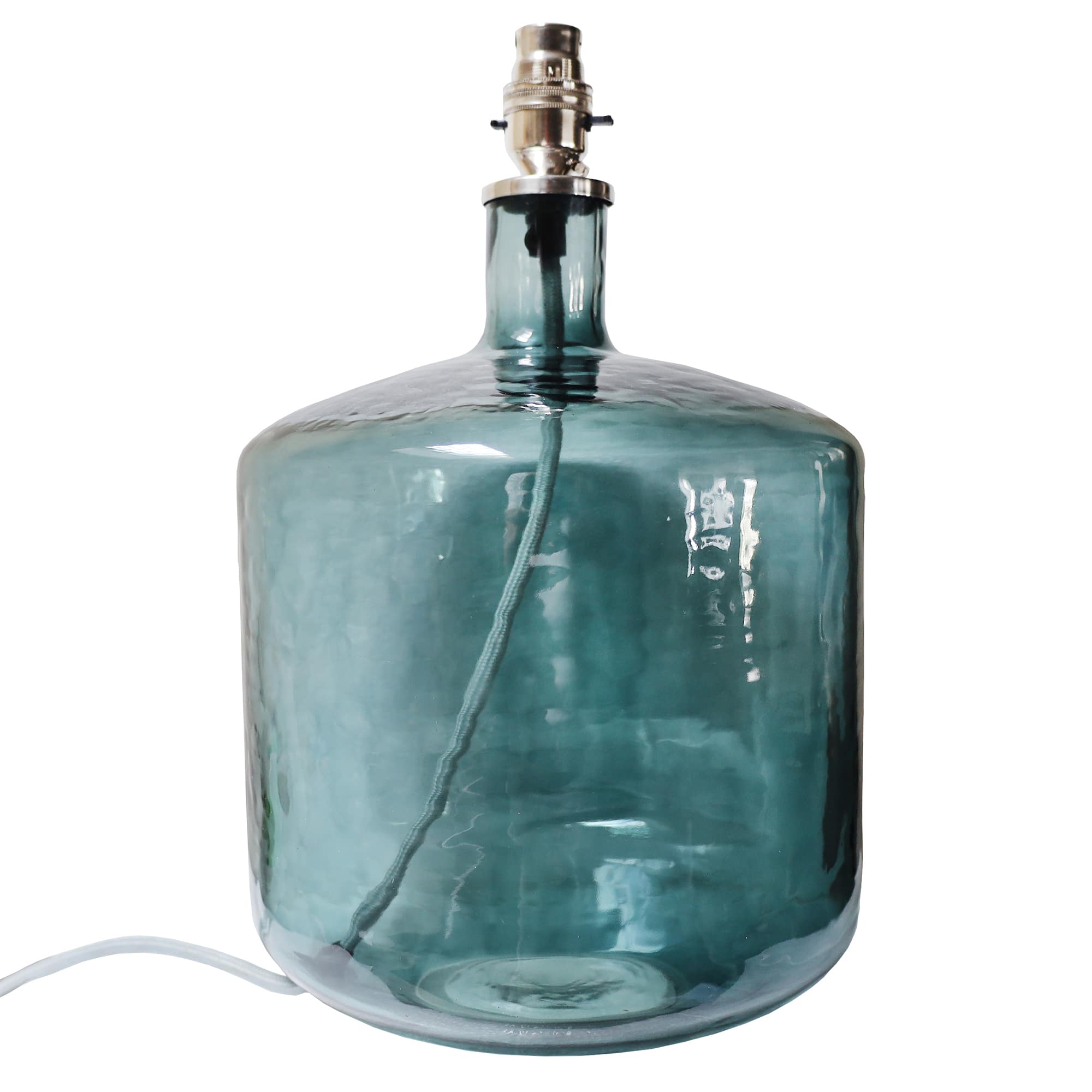 A broad, light blue glass lamp base with a cylindrical, drum-like shape. The base features a smooth, reflective surface and a visible cord running through the center, leading up to a polished silver light socket at the top. Its simple yet bold design makes it a striking piece for modern home decor.