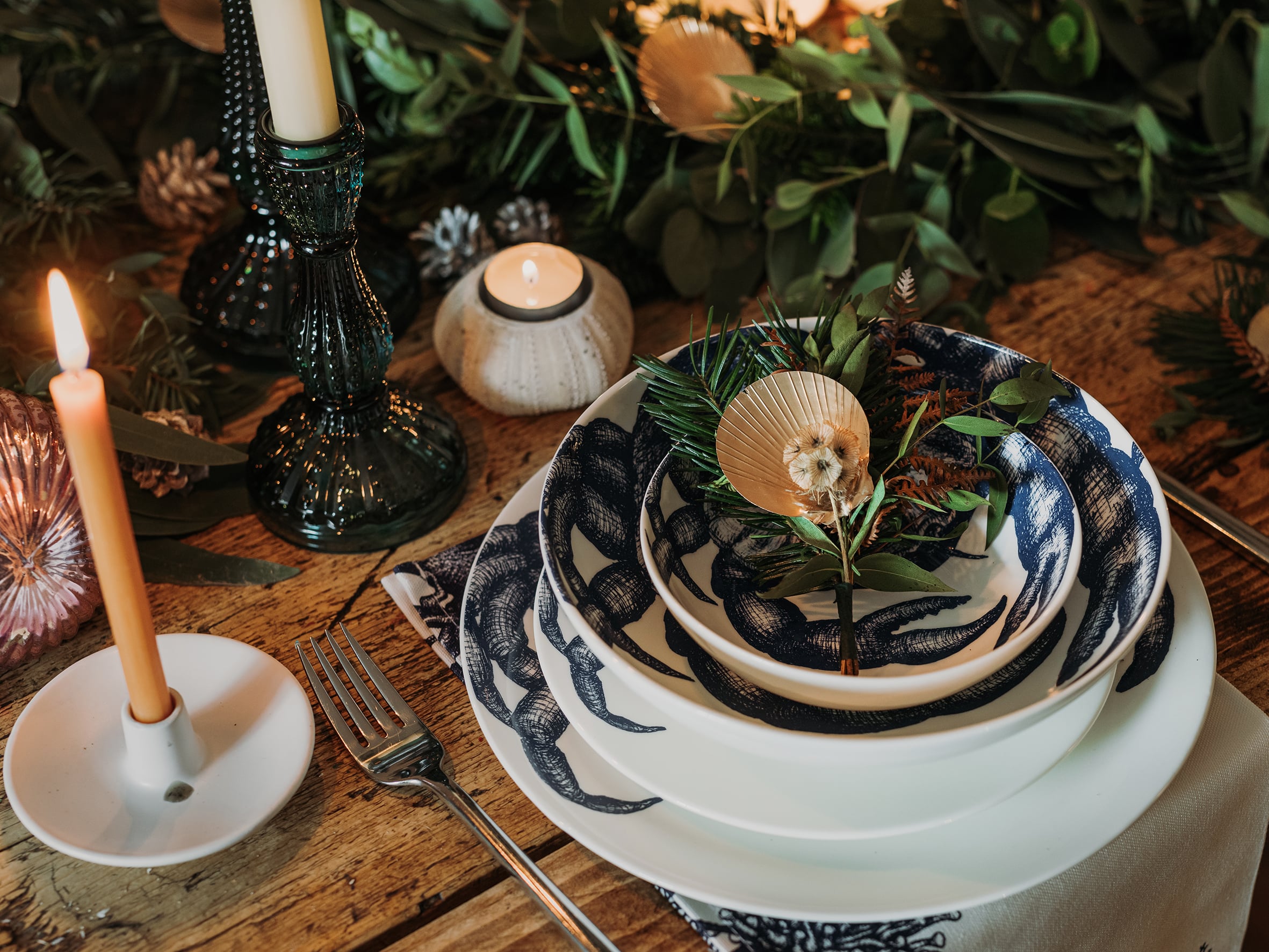 Pasta bowl in Bone China in our Classic range in Navy and white in the Crab design,placed on a Crab dinner plate and has a smaller bowl placed inside.All are on a table setting and the table is decorated with foliage and candle holders