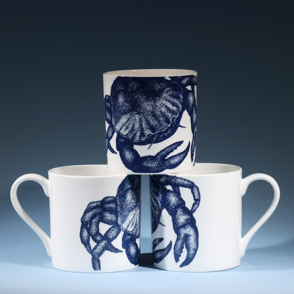Bone china white mug featuring hand drawn Crab  design in classic Navy stacked in three showing all sides