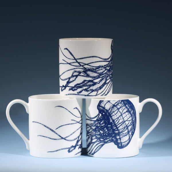 The photo shows Bone china white mug featuring hand drawn jellyfish design in classic Navy stacked in a set of three showing all sides