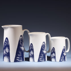 Three Bone China white Jugs with hand drawn illustration of our Mackerel head design in Navy.There are three sizes Large,Medium and the small
