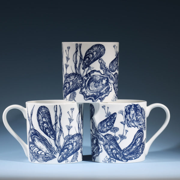 Bone china white mug featuring hand drawn Mussel and Oyster design in classic Navy stacked in three showing all sides