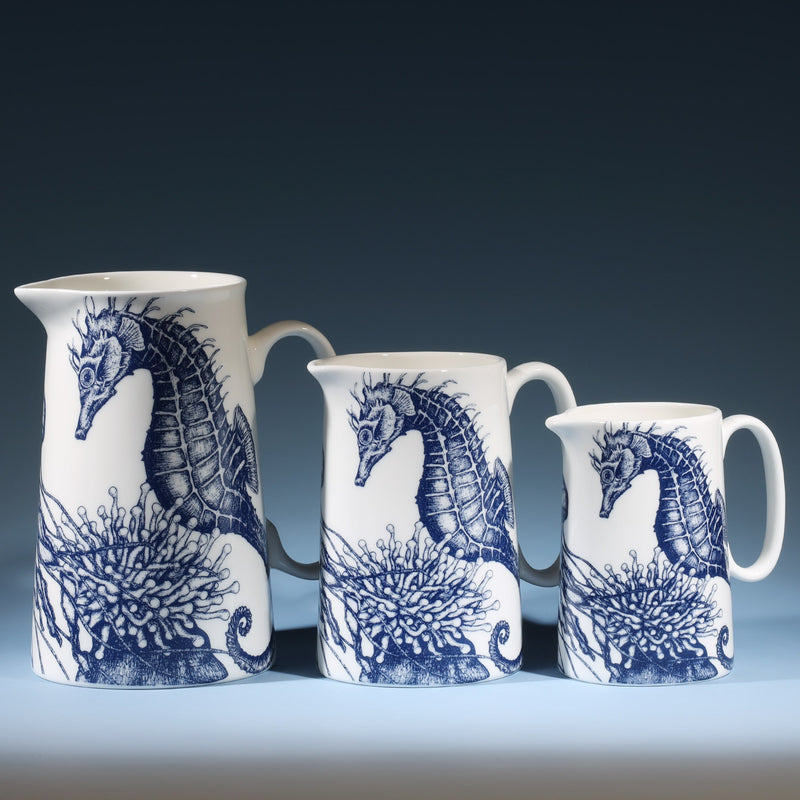 Three Bone China white Jugs with hand drawn illustration of our Seahorse with Anemone and Jellyfish  in Navy.There are three sizes Large,Medium and the small