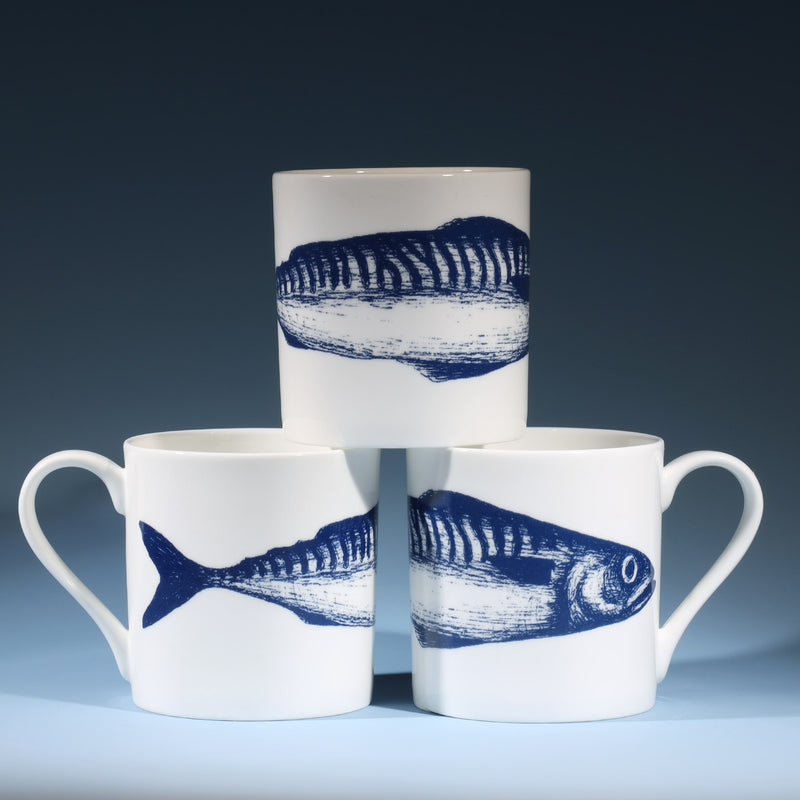 Bone china white mug featuring hand drawn Single Mackerel design in classic Navy stacked in three showing all sides of the mug
