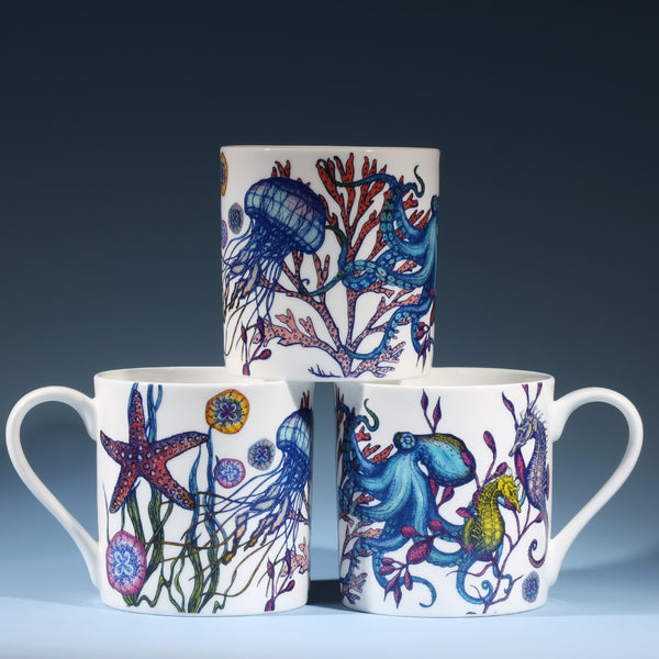 Image of three bone china mugs featuring an underwater Reef Design with Octopus, Jellyfish and Starfish stacked on top of each other