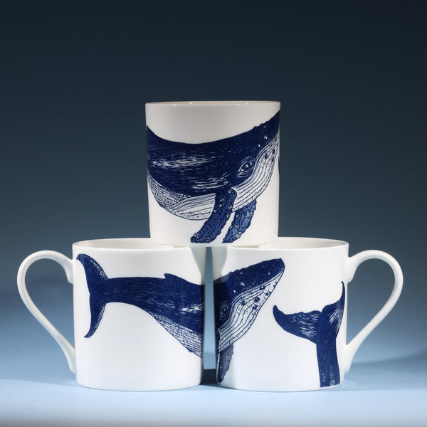 Bone china white mug featuring hand drawn Whale design in classic navy stacked in three showing all sides